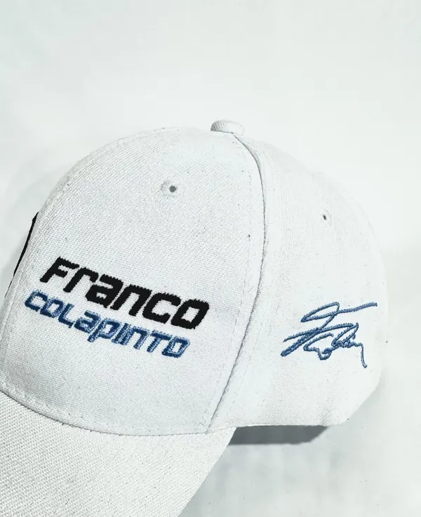 Gorra blanca con bordado de Franco Colapinto y firma en el lateral
